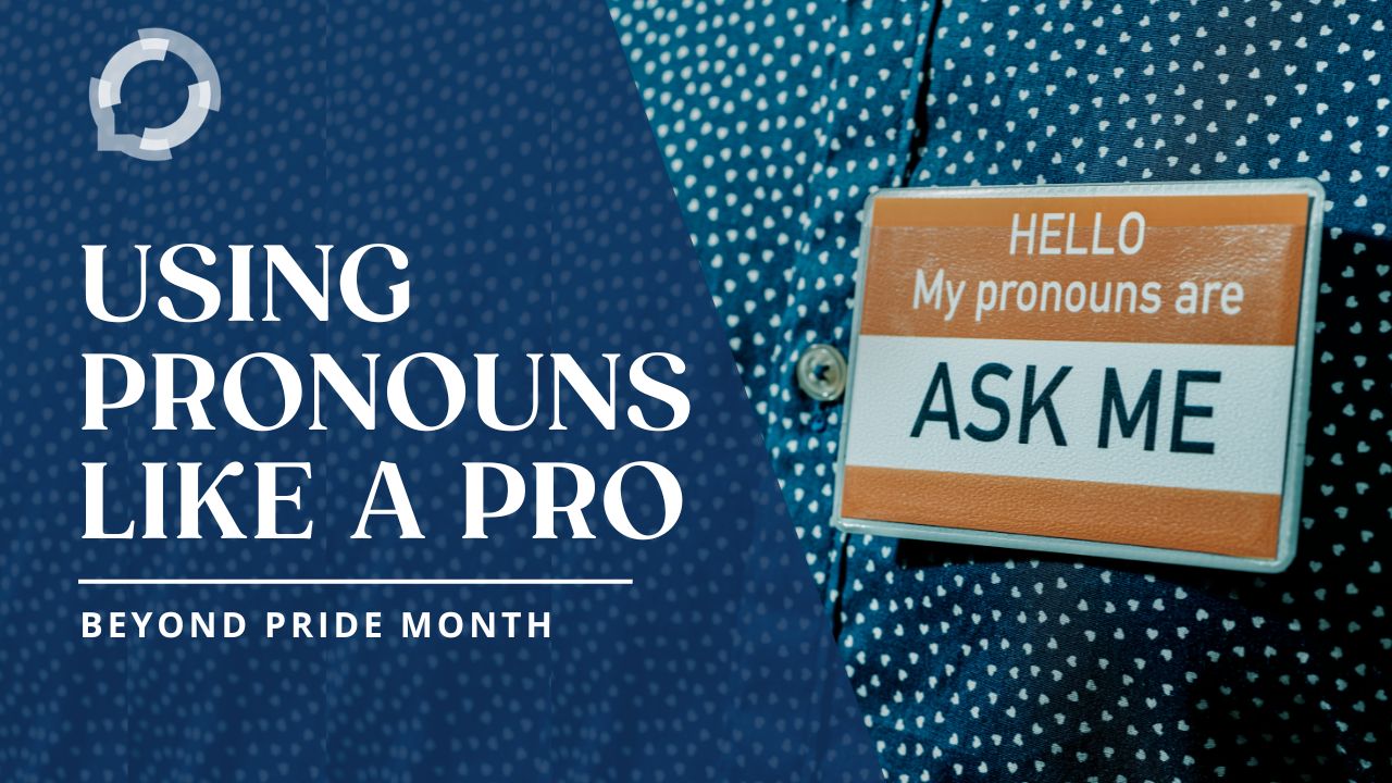 Photo of a blue button-up shirt with small white hearts. The person is wearing a name tag that says "Hello, my pronouns are Ask Me". The title reads, "Using Pronouns like a Pro: Beyond Pride Month"